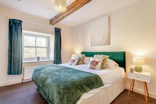 a bedroom with a large bed and a window at 4 Bed in Borrowby oc-o36892 in Borrowby