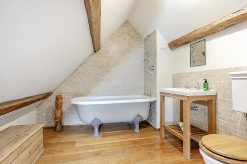 a bathroom with a white bath tub and a sink at 4 Bed in Borrowby oc-o36892 in Borrowby