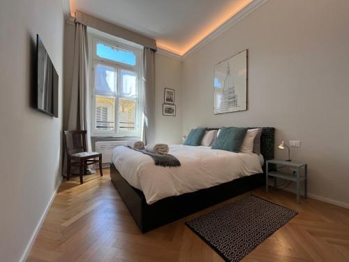 a bedroom with a large bed and a window at Suite Florio in Turin