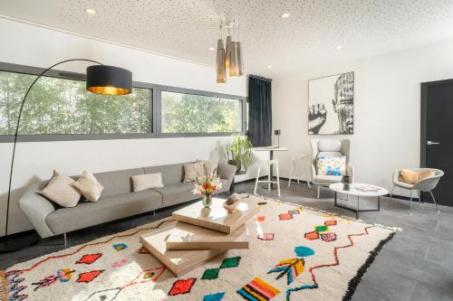 a living room with a couch and a table at BW Plus Central Park Hotel & Spa in La Rochelle