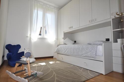 a bedroom with a bed and a blue teddy bear at Casa la Pianca in Menaggio