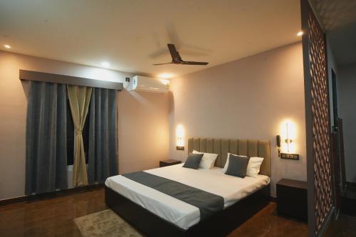a bedroom with a bed and a window at Kasa Courtyard Hotel in Begusarai