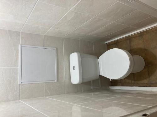 a bathroom with a white box on the wall at Apiņa 18 in Valmiera