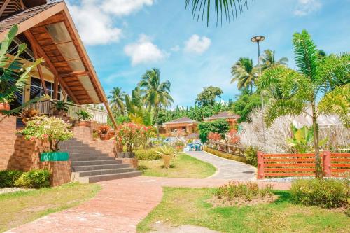 a resort with a pathway leading to a building at Gamboa's Orchard Malilipot Albay in Malilipot
