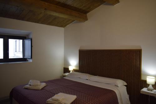 a bedroom with a large bed with two towels on it at Il Borgo civ 25 in Paola