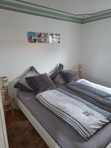 a bed with two pillows on it in a bedroom at Pension Fiete Celle in Celle