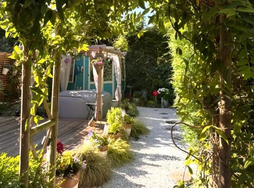 a garden with a pergola and some plants at Cosy Garden Accommodation, Private Hot Tub & Four Poster Bed in York
