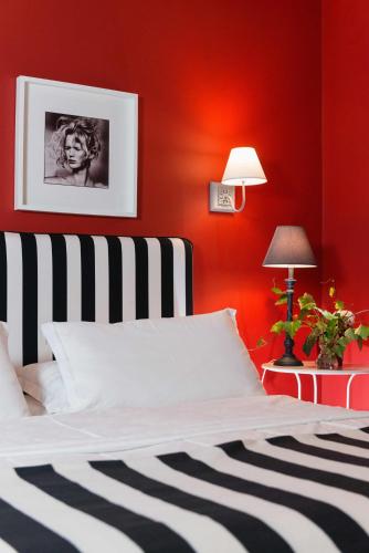 a red bedroom with a bed and a red wall at Areela Boutique Hotel in Tirana