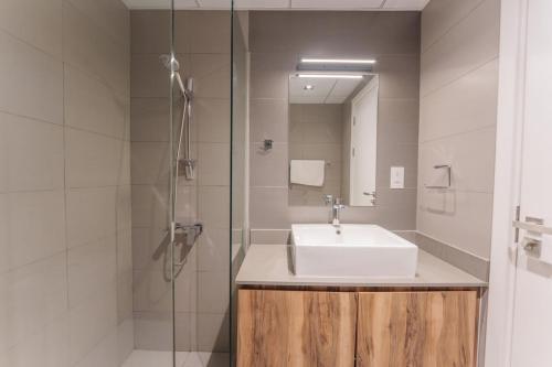 a bathroom with a sink and a shower at Golden Sunset Luxe 1BR CB2-3-RA1-812-1br in Sabkhah