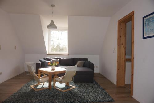 a living room with a couch and a table at Ferienwohnung in Möllenhagen