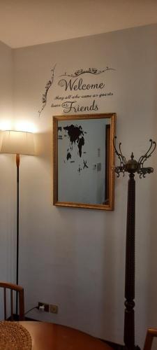 a mirror on a wall with a picture on it at Incoming in ROME in Acilia