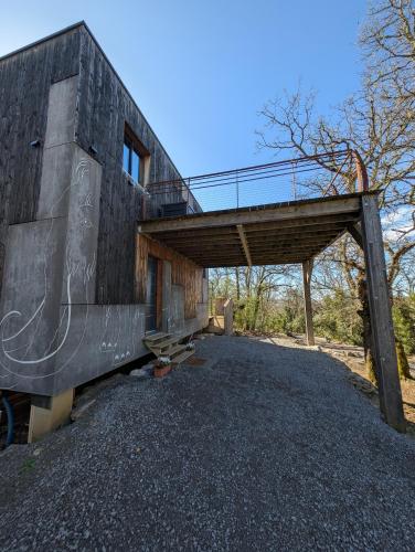 a building with a wooden structure with a bridge at Villa Mammouth in Saint Alban Auriolles