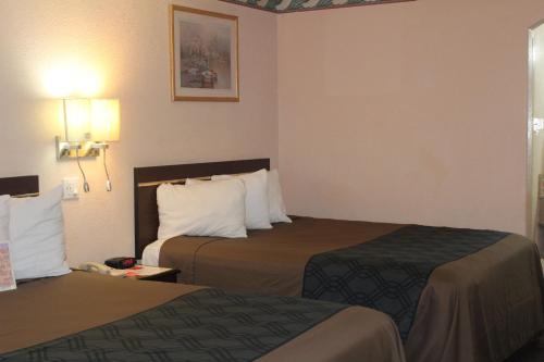 a hotel room with two beds in a room at Americas Best Value Inn-Near NRG Park/Medical Center in Houston