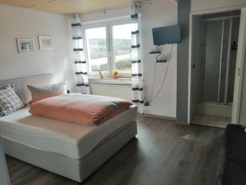 a bedroom with a bed and a window at Ferienwohnung in der Rhön in Willmars