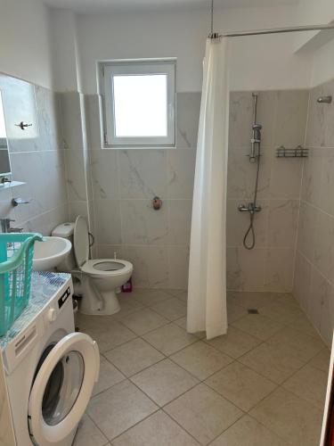 a bathroom with a shower and a toilet and a sink at Villa Alba in Ezerets