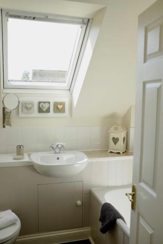 a bathroom with a sink and a window at The Hayloft, Wonderful Riverside Accommodation in Bodenham