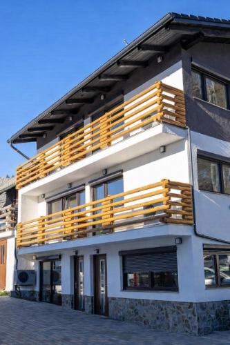 a building with wooden balconies on top of it at Apartmaji Ježek Kope in Šmartno pri Slovenj Gradcu
