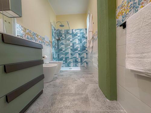 a bathroom with a shower and a toilet and a sink at ToNo House in Paterno