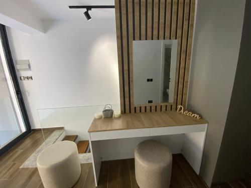 a dressing room with a mirror and two stools at Loft One Bedroom with Shared Private Pool in Aglantzia