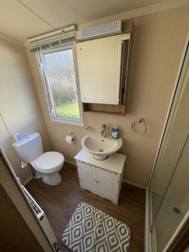 a small bathroom with a toilet and a sink at Cleethorpes Beach Haven - Broadland Drive in Cleethorpes