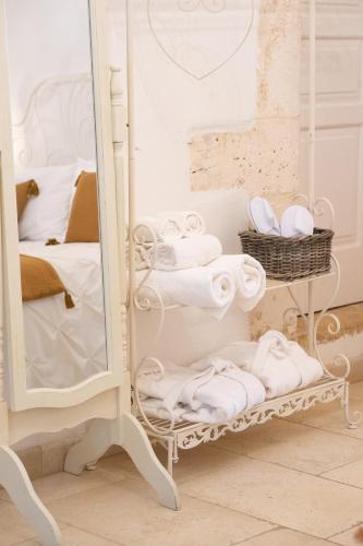 a room with a mirror and a rack of towels at Masseria Luco in Martina Franca