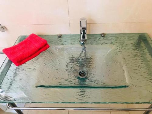 a sink with a red sponge on top of it at Marina d'Or III - Villa 10 in Santanyi