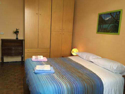 a bedroom with a bed with two towels on it at House Steccuto in Florence