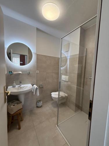 a bathroom with a shower and a sink and a toilet at Pension am Markt in Lübben
