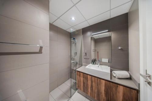 a bathroom with a sink and a mirror at The Clay Loft Stylish 1BR with Pool Parking CB2-1-RA2-707-1br in Sharjah