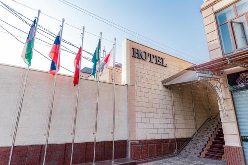 a group of flags on the side of a building at BEX SUENO HOTEL in Samarkand