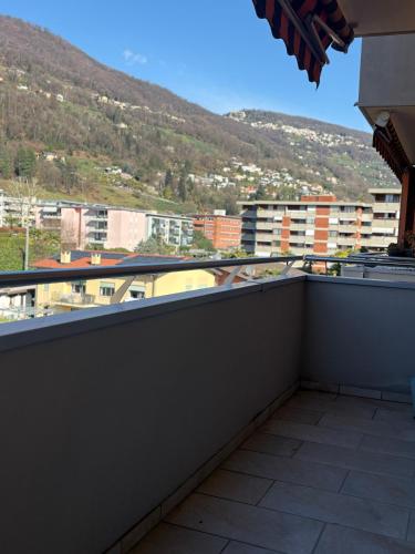 a balcony with a view of a city at Lake Agno Apartment in Agno