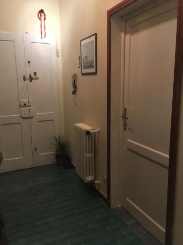 a hallway with an open door and a radiator at House Steccuto in Florence