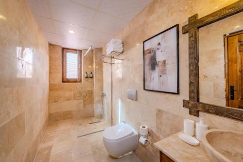 a bathroom with a toilet and a sink at Pegas Goreme in Göreme
