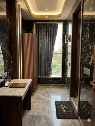 a bathroom with a shower and a large window at Hotel The Tark Near Delhi Airport in Champawat