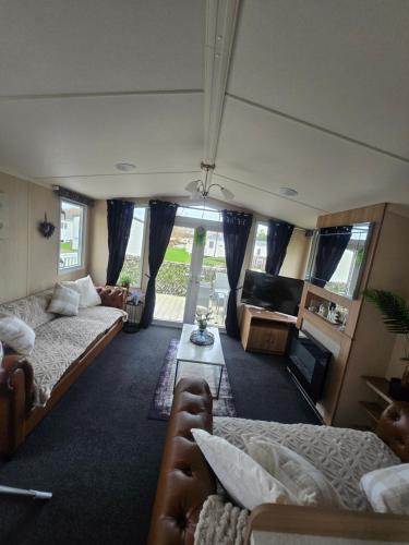 a living room with two beds and a couch at Castle Lakes 60 - Wifi Included in Goswick Station