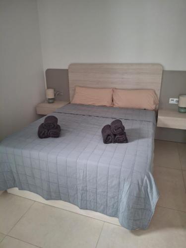 a bedroom with a bed with towels on it at Casa la Pluma Torrevieja in Torrevieja