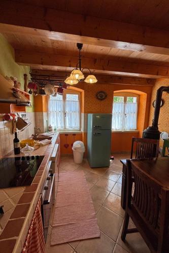a kitchen with a green refrigerator in a room at Villa Mela by Villas Guide in Barban