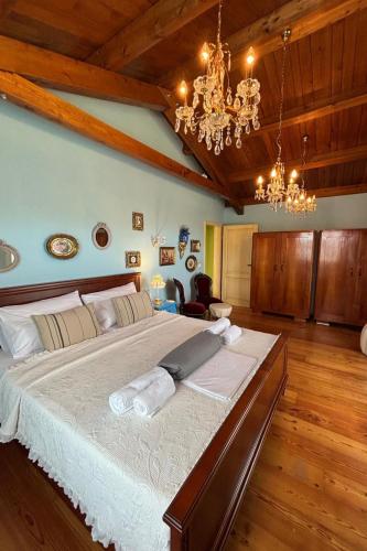 a large bedroom with a large bed with a chandelier at Villa Mela by Villas Guide in Barban