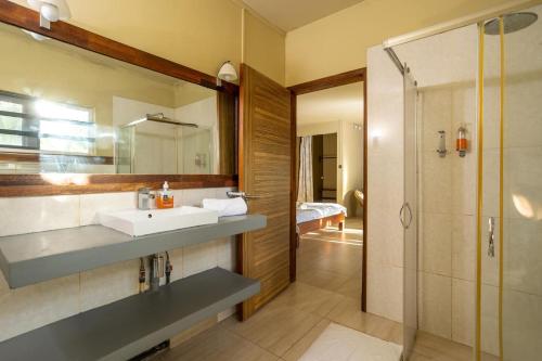 a bathroom with a sink and a shower at Authentic Nest in La Gaulette