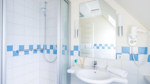 a bathroom with a sink and a shower at Hapimag Resort Dünenblick in Westerland