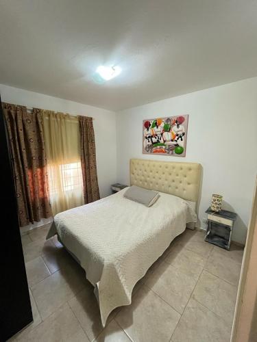 a bedroom with a bed in a room at Departamento duplex Pinamar in Pinamar