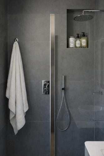 a bathroom with a shower with a glass door at Da Lorenzo Luxury Apartment in Bologna