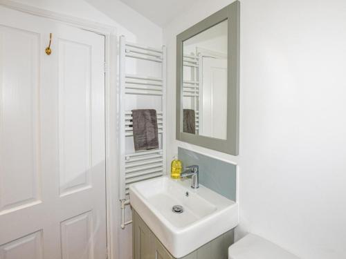 a white bathroom with a sink and a mirror at 3 Bed in Whitstable oc-wcc07 in Whitstable
