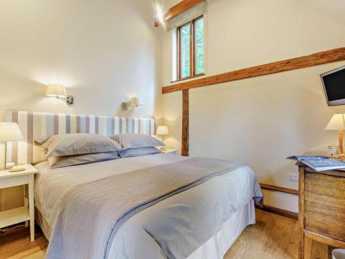a bedroom with a large bed and a window at 1 Bed in Battle oc-94675 in Warbleton
