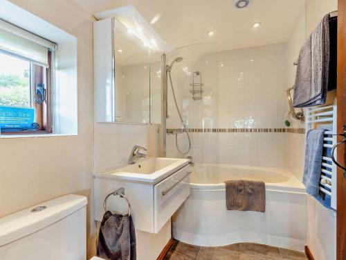 a bathroom with a sink and a tub and a shower at 1 Bed in Battle oc-94675 in Warbleton