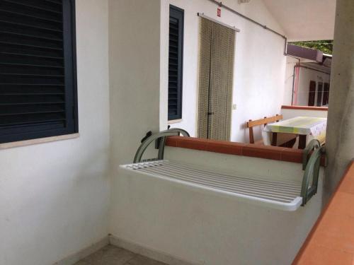 a balcony with a bench on the side of a building at Chalet Pineta Mare in Foce Varano