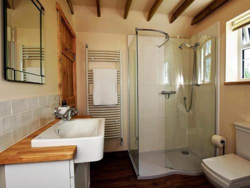 a bathroom with a sink and a glass shower at 1 Bed in Etchingham oc-62641 in Burwash