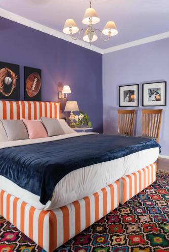 a bedroom with a large bed with purple walls at Areela Boutique Hotel in Tirana