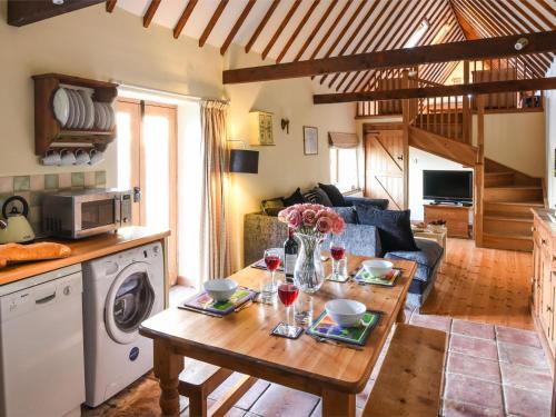 a kitchen and living room with a table with wine glasses at 2 Bed in Briston oc-kt009 in Briston