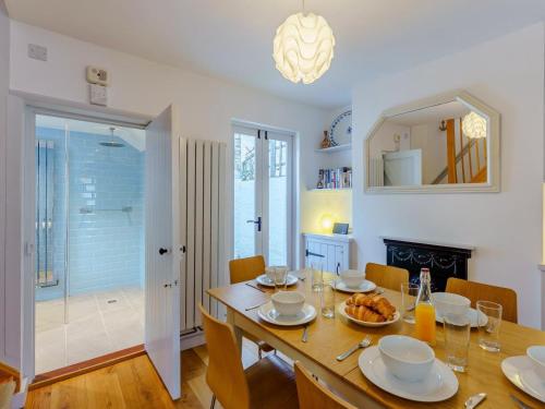 a dining room with a table and chairs and a mirror at 3 Bed in Whitstable oc-wcc12 in Whitstable